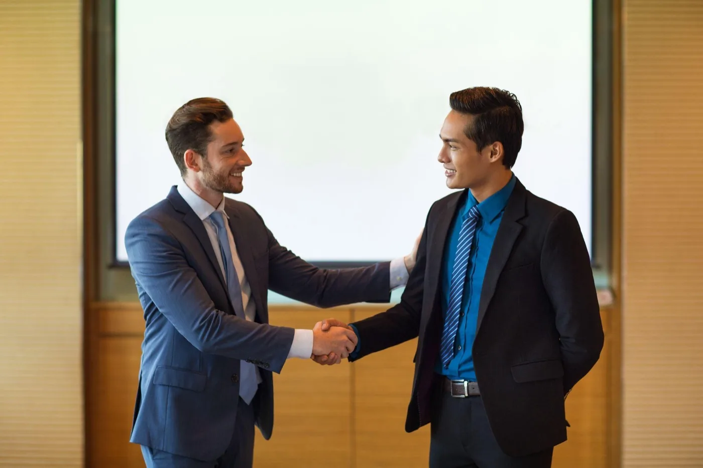 Two professionals shaking hands after reaching an agreement